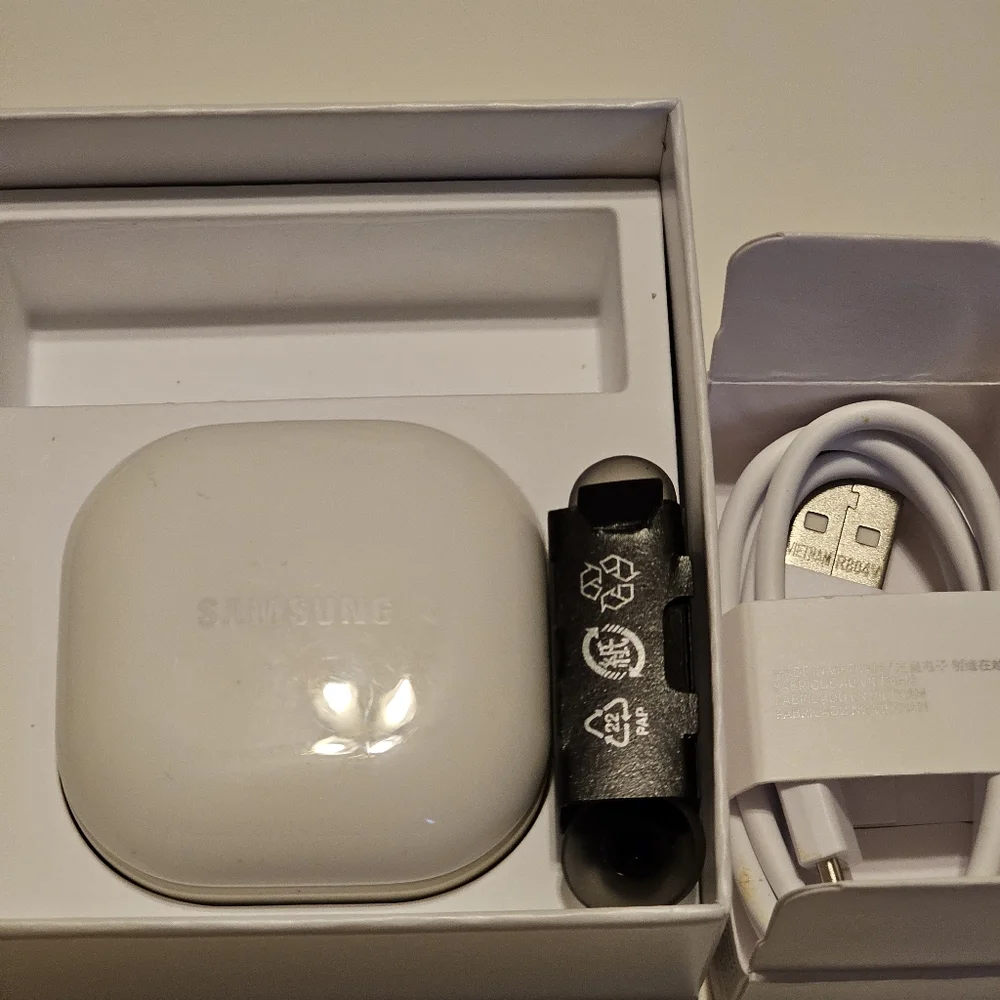 Samsung Galaxy Buds2, black in a white case.